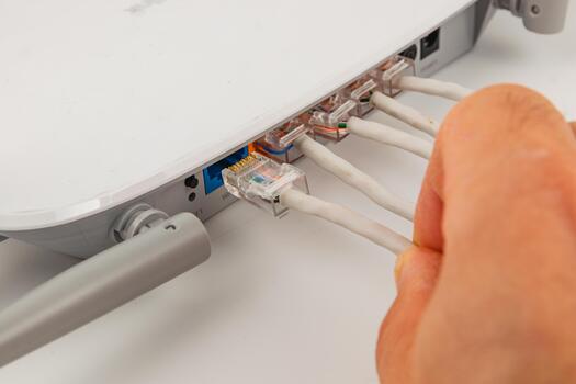 Connecting network cables to a router for internet access installation photo