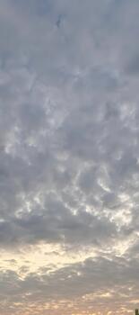 Dramatic cloudscape with golden light peeking through, perfect for adding depth and emotion to your next project, creating a serene and calming atmosphere photo