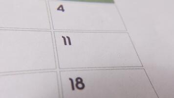 märkning de datum siffra 11, fokusera på de siffra markerad med en röd korsa på de kalender. representerar deadlines, påminnelser, planera, och tid förvaltning video