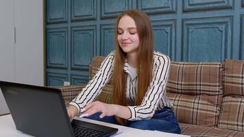 Woman freelancer works on laptop, girl using computer at home, busy developer programmer, trader monitoring stock online earning bitcoins by trading operations. Increasing wealth, financial prosperity video