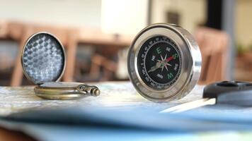 Compass and map displayed on table for navigation planning video