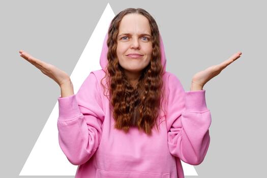 A person stands with a slightly puzzled expression, displaying open hands in a questioning gesture photo