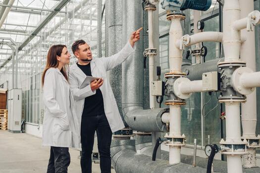 Supervisor reviews infrastructure, engineer assesses equipment status, team reviews piping systems and measurement tools, design team discusses upgrade plans and scheduling strategies photo