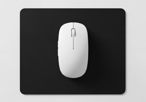 Simple White Computer Mouse on Black Mousepad Minimalist Workplace photo