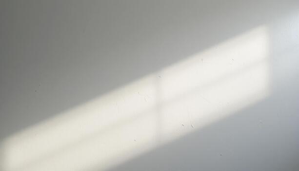 Sunlight Casting Patterns on a Clean White Surface in a Bright Room During the Day photo