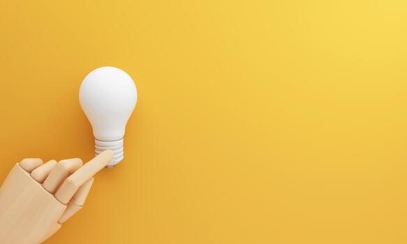 A wooden hand pointing at a white bulb indicates choosing the right idea and turning inspiration into action through smart thinking strategy and creativity. 3d rendering. photo