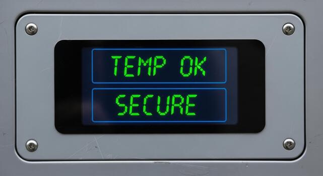 Secure control panel display with green text shows temp ok. This digital interface provides confidence and security for industrial logistics and system operations photo