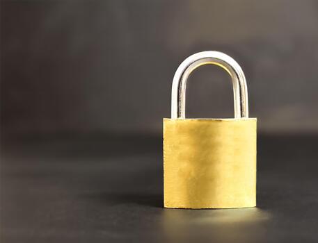 Bronze colored padlock on a gray background, security concept, cybersecurity and data protection concept, with empty space for text photo