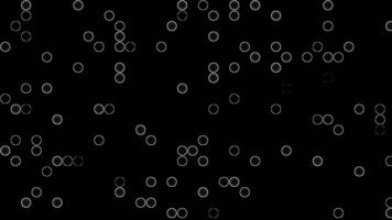 Animation minimalist abstract pattern of white glowing circles scattered on a black background. geometric circle motion. video