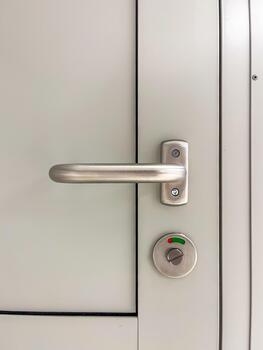 Modern door handle with sleek metallic finish and circular lock mechanism, showcasing minimalist design and functionality in contemporary architecture photo