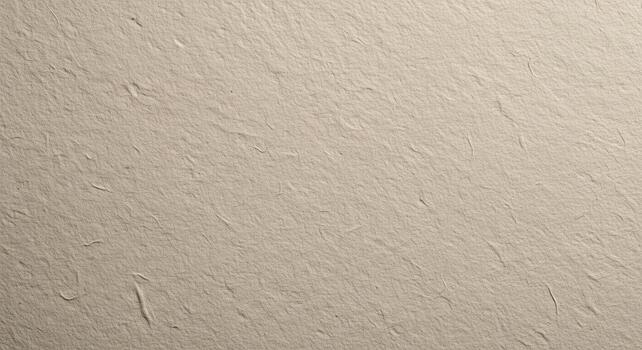 A close up shot of a beige textured surface with small fibers and uneven patches across the frame photo