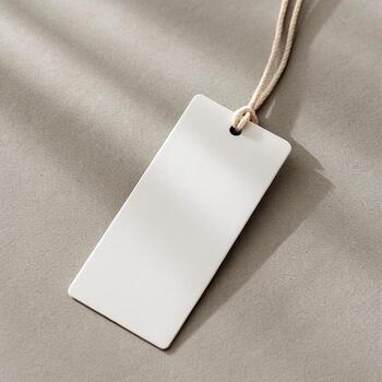 Minimal Rectangular Tag on Neutral Background -- Clean white tag with soft shadows on a beige or grey matte surface photo