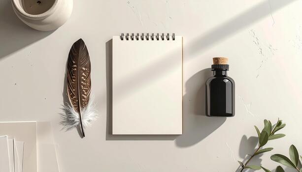 Top down view of a feather quill, ink bottle, notebook, and paper on a desk surface background scene photo