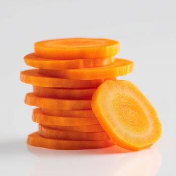 A stack of fresh carrot slices with one slice placed beside it, isolated on white background, showing texture and bright orange color photo
