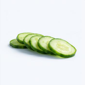 A neat row of thinly sliced cucumber rounds, displaying their fresh green edges and delicate seed patterns, isolated on white background photo