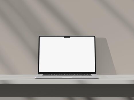 Modern laptop on a minimal desk with empty screen and soft shadows. photo