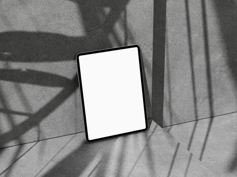 Tilted tablet mockup leaning on corner step, dynamic shadows for app or web. photo