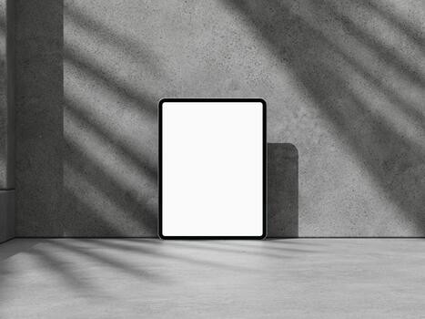 Tablet screen mockup on concrete wall, centered with soft shadows for app or web. photo