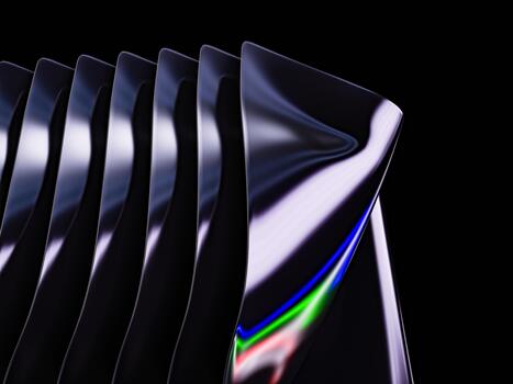 Glossy metallic textures creating smooth curved patterns against a black background. photo