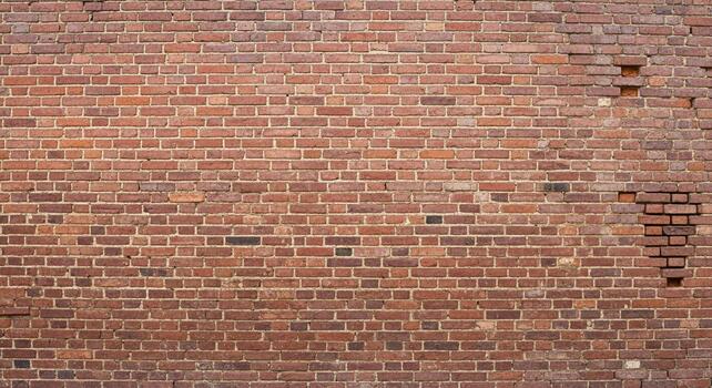 Authentic weathered red brick wall texture offers rustic charm and rugged durability for any design project. photo