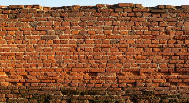 Weathered red brick wall texture offers rustic charm and authentic background for architectural projects or historical storytelling photo