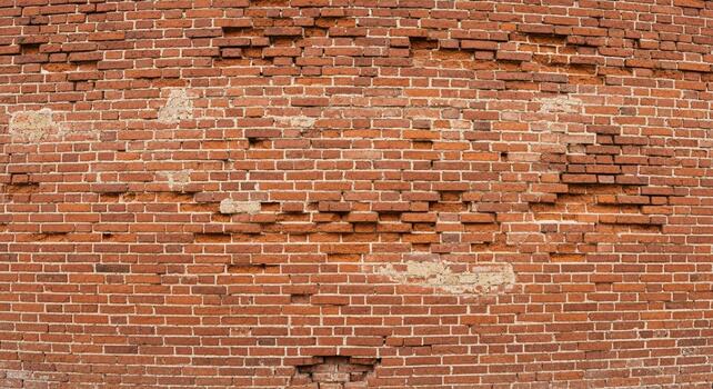 Rustic charm showcases a vibrant red brick wall with distressed detailing, perfect for adding character and texture to your designs photo