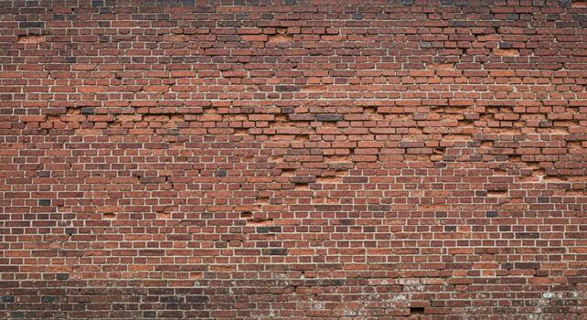 Weathered red brick wall texture with visible damage creating character and depth for background design projects photo