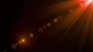 un' drammatico arancia leggero bagliore con bokeh effetto su un' buio sfondo la creazione di un' dinamico visivo effetto video