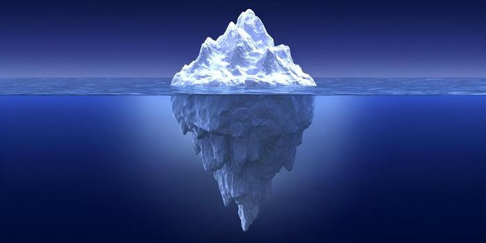 A large iceberg floats in the blue ocean showing its hidden underwater mass representing the vast unseen part of a problem or concept photo