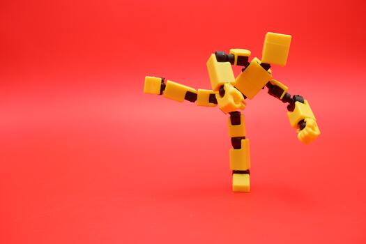 Creative Yellow Robot Toy in Dynamic Kicking Action photo