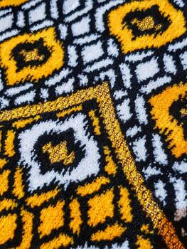 Abstract Geometric Fabric Texture with Gold Trim, White, Black and Yellow photo