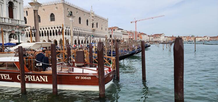 A boat is docked at a dock in front of a building photo