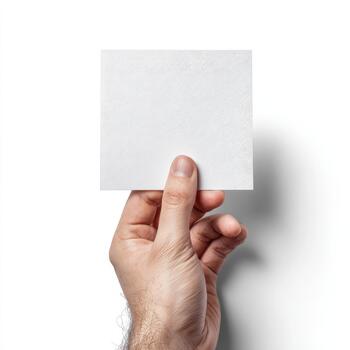A hand displays a blank square piece of white paper, emphasizing simplicity and potential creativity. photo