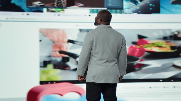 Joyous man using phone, receiving personalized recommendations delivered instantly. Upbeat user using smartphone, enjoying digital era enabling unlimited streaming opportunities photo