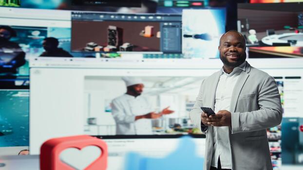 Cheerful man using smartphone surrounded by curated recommendations while browsing streaming services. Happy man enjoying free time browsing favorite online clips on phone, camera A photo
