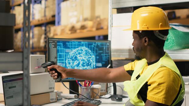 Black worker scanning to register shipping labels tracking info with AI brain, package tracking software helps handling online shopping orders with neural networks automation. Camera B. photo