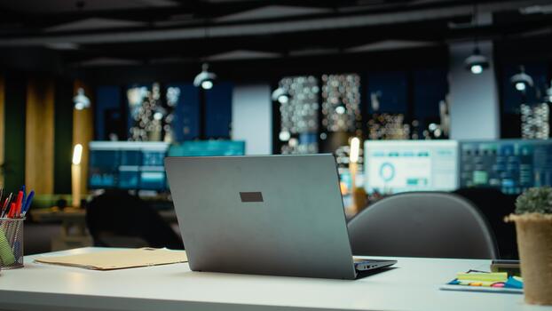 Modern empty office glows with the light of performance metrics and forecasting graphs. Corporate space equipped with technology and computers reflects administration of enterprise objectives. photo