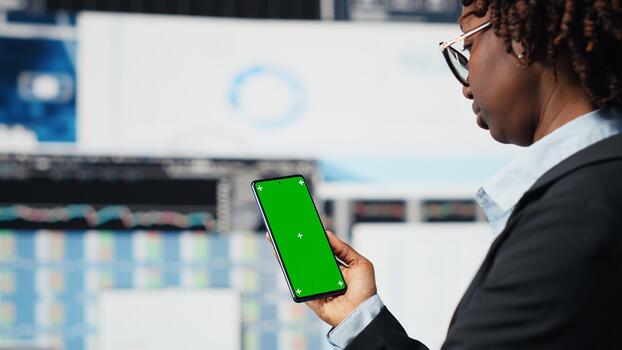 Green screen mockup phone used by manager evaluating business market graphs doing brainstorming. Businesswoman analyzing financial reports and data charts on isolated screen chroma key phone, camera B photo