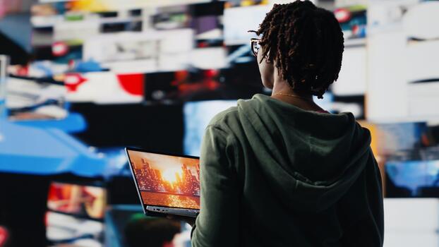 Person entertained by clips on laptop, enjoying technology bridging people worldwide. Woman using online services on notebook to look at videos, enjoying digital age lifestyle, camera B photo