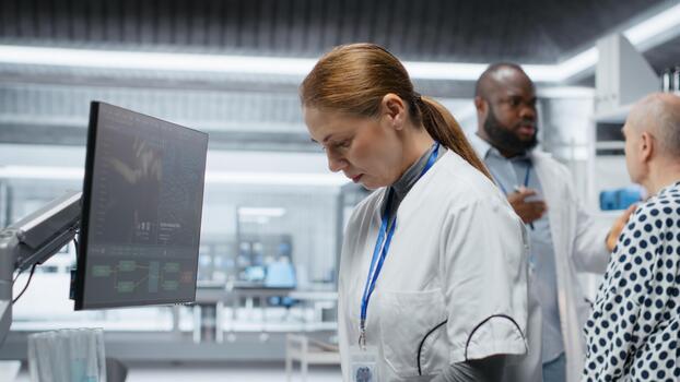 Scientist examines test tubes with blood in modern laboratory setting, testing a new drug and recording side effects. Analyzing dosage response to ensure safety and effectiveness. Camera B. photo