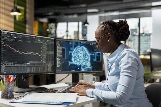 Trader running AI technology on computer to do automated trading and portfolio rebalancing. African american woman applying deep learning algorithms to analyze complex market data photo