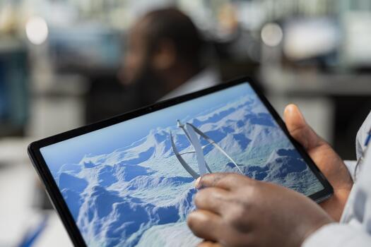 Close up of engineer using touchscreen device to analyze advanced wind turbine models to improve efficiency and environmental performance. Designer creates innovative VAWT turbine in CAD app on tablet photo