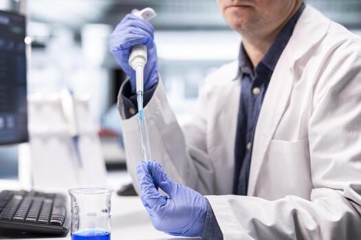 Close up of scientist preparing solution using pipette and jars in clinical laboratory. Experiment highlighting research in molecular science, microbiology and biotechnology for discovery. photo