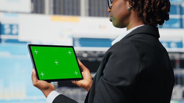 Green screen tablet used by business specialist to review performance dashboards metrics. Management executive evaluating annual report data using chroma key device app, close up photo