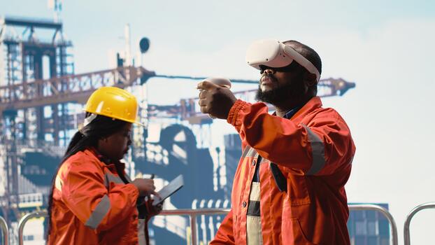 Offshore rig worker supervising deck operations using virtual reality simulation, ensuring compliance with safety protocols. Engineer doing checkup on drilling rig with VR goggles photo
