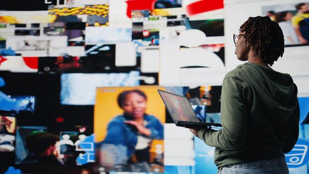 Smiling woman using laptop satisfied by access to recommendations delivered instantly. Joyful user has fun in digital era enabling unlimited streaming, looking at clips on notebook, camera A photo