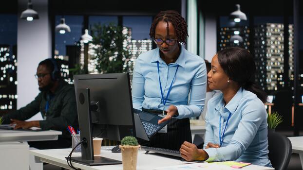Business manager and analyst monitoring data insights at the workspace, utilizing analytics to plan forecast for detailed performance metrics and statements. Goal setting after hours. photo