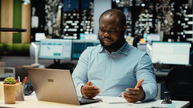 African american strategist ripping a paper after writing the wrong idea, restarting work in rage and crumpling the page sheet. Discontent man does a typo mistake while transcribing. photo