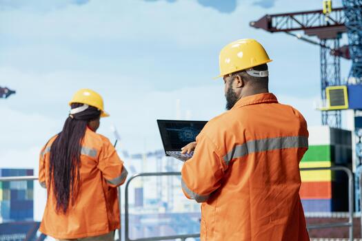 Offshore platform specialist evaluates AI metrics on laptop to refine operational efficiency. African american man using artificial intelligence to monitor drilling production activities photo