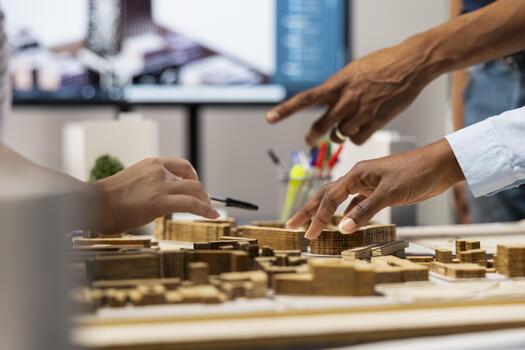 Close up of developers creating the layout for a residential project, simulating site preparation with 3D models before the construction. City planning and modern redevelopment. photo